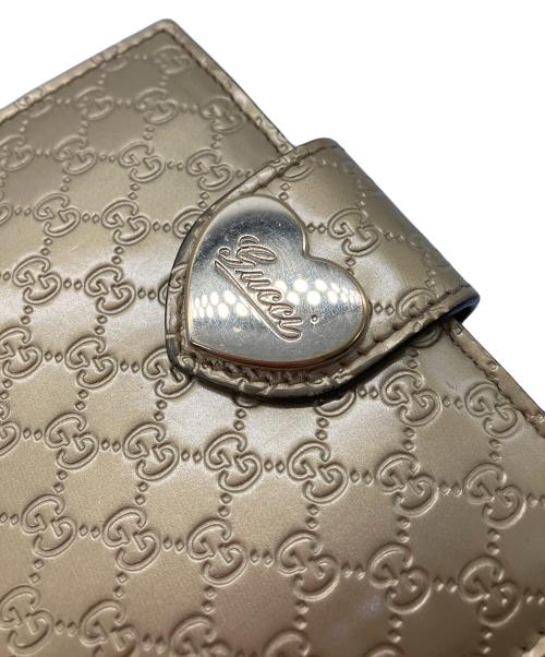 GUCCI（グッチ）GUCCI (グッチ) 2つ折り財布　GUCCI　ゴールド　GG総柄　ハートプレート ゴールドの古着・服飾アイテム