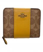 COACHコーチ）の古着「ラウンドファスナー財布」｜ブラウン×イエロー