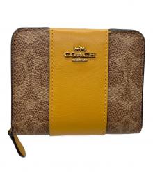 COACH（コーチ）の古着「ラウンドファスナー財布」｜ブラウン×イエロー