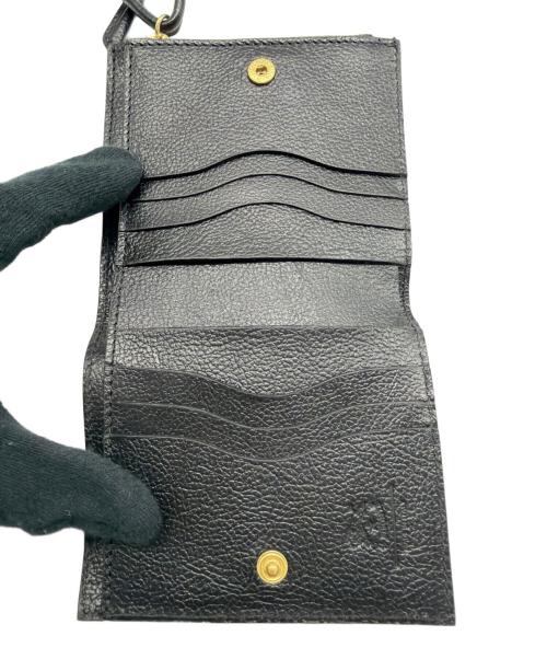 IL BISONTE（イル ビゾンテ）IL BISONTE (イル ビゾンテ) レザーストラップ付き2つ折り財布 ブラックの古着・服飾アイテム