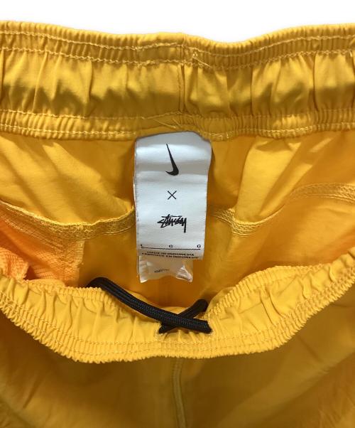 NIKE（ナイキ）NIKE (ナイキ) stussy (ステューシー) NIKE × stussy トレーニングパンツ オレンジ サイズ:Lの古着・服飾アイテム