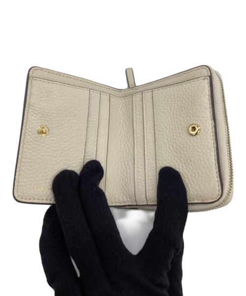 TORY BURCH（トリーバーチ）TORY BURCH (トリーバーチ) 2つ折り財布 ベージュの古着・服飾アイテム