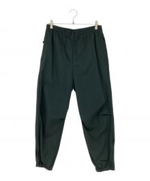 UNIVERSAL PRODUCTS.（ユニバーサルプロダクツ）の古着「ナイロンシェルトラックパンツ」｜グリーン