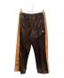 Needles（ニードルズ）の古着「トラックパンツ」｜ブラウン×オレンジ