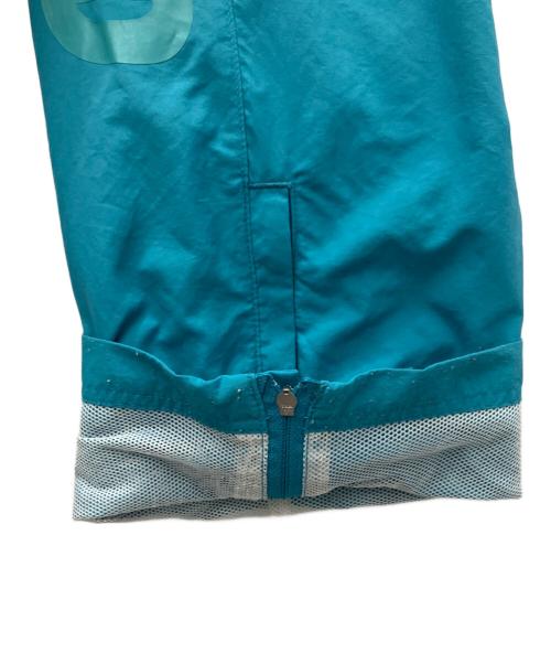 Champion（チャンピオン）Champion (チャンピオン) UNDEFEATED (アンディフィーテッド) ナイロンパンツ ブルー サイズ:XLの古着・服飾アイテム
