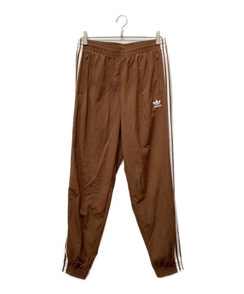 adidas（アディダス）adidas (アディダス) アディカラー ウーブン ファイヤーバードトラックパンツ ブラウン サイズ:Lの古着・服飾アイテム