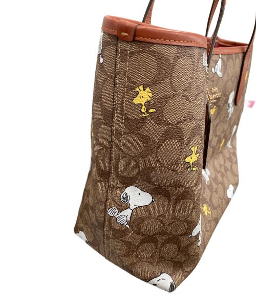 COACH（コーチ）COACH (コーチ) PEANUTS (ピーナッツ) トートバッグ シティ トート・シグネチャー・スヌーピー ウッドストック ブラウン サイズ:実寸サイズにてご確認ください。の古着・服飾アイテム