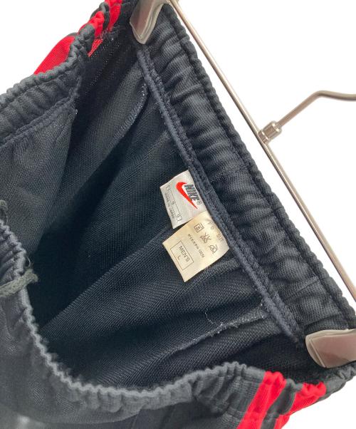 NIKE（ナイキ）NIKE (ナイキ) トラックパンツ ブラック×レッド サイズ:MEN'S Lの古着・服飾アイテム