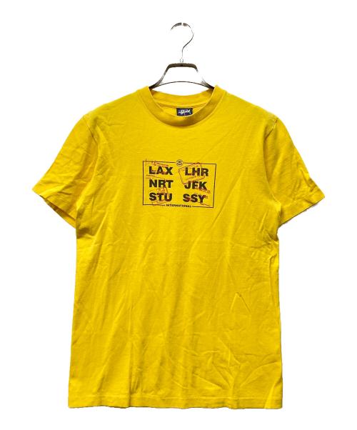 stussy（ステューシー）stussy (ステューシー) 国際空港コード プリントTシャツ イエロー サイズ:Sの古着・服飾アイテム