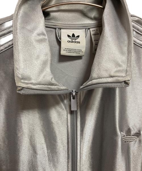 adidas（アディダス）adidas (アディダス) オーバーサイズ ファイヤーバード トラックトップ シルバー サイズ:Mの古着・服飾アイテム