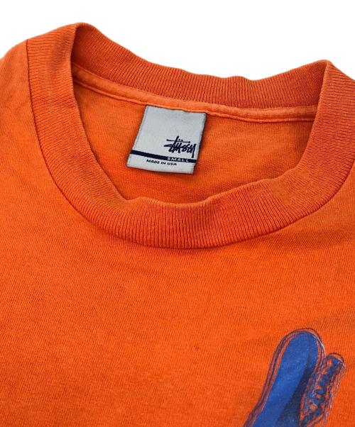 stussy（ステューシー）stussy (ステューシー) The CRASH プリントTシャツ オレンジ サイズ:Sの古着・服飾アイテム