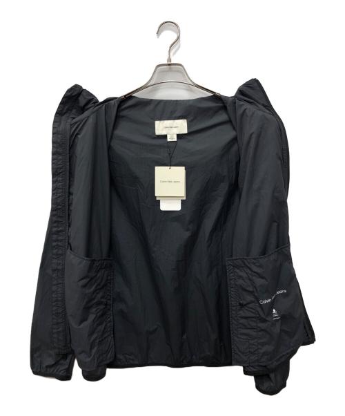 Calvin Klein Jeans（カルバンクラインジーンズ）Calvin Klein Jeans (カルバンクラインジーンズ) ウインドブレーカージャケット グレー サイズ:SIZE Mの古着・服飾アイテム