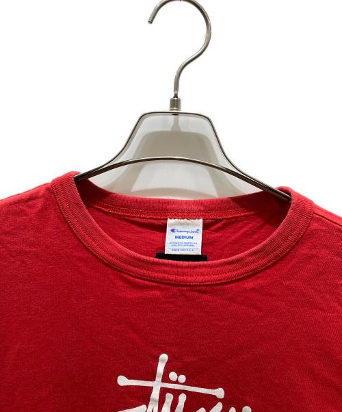 stussy（ステューシー）stussy (ステューシー) Champion (チャンピオン) 半袖Tシャツ レッド サイズ:Mの古着・服飾アイテム