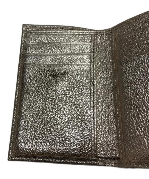 ANYA HINDMARCH（アニヤ・ハインドマーチ）ANYA HINDMARCH (アニヤ・ハインドマーチ) ミニトライフォールドウォレット シルバーの古着・服飾アイテム