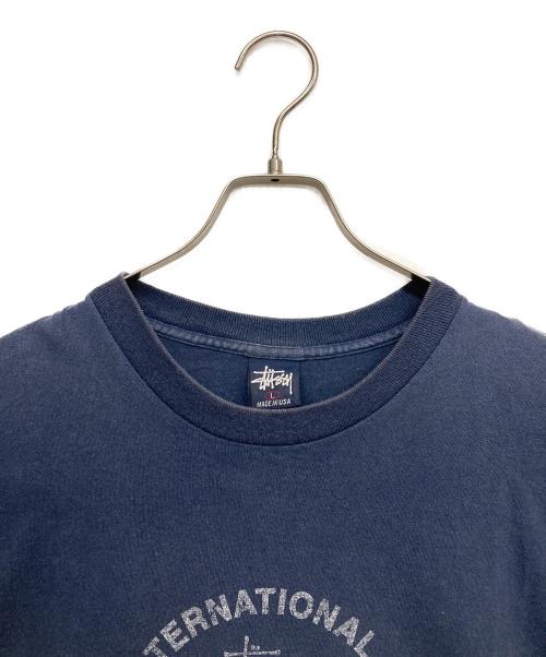 stussy（ステューシー）stussy (ステューシー) スカルインターナショナルプリントTシャツ ネイビー サイズ:Lの古着・服飾アイテム