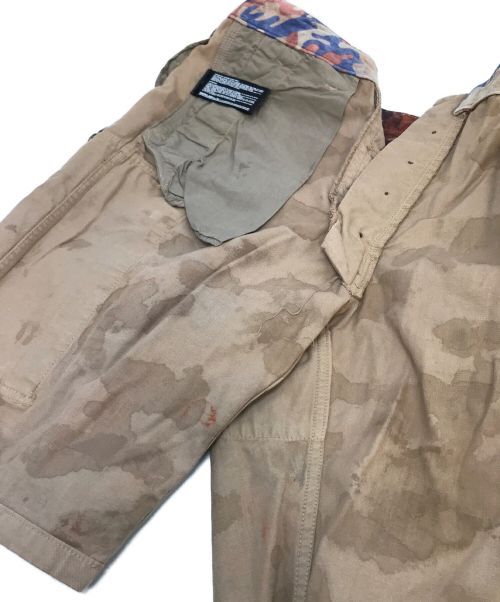 ISAMU KATAYAMA BACKLASH（イサムカタヤマ・バックラッシュ）ISAMU KATAYAMA BACKLASH (イサムカタヤマ・バックラッシュ) 迷彩ペイントハーフカーゴパンツ ブラウン サイズ:Sの古着・服飾アイテム