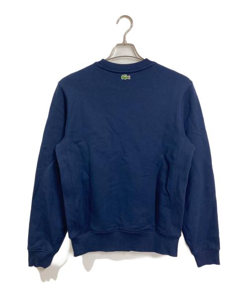 LACOSTE（ラコステ）LACOSTE (ラコステ) フロッキーオーバルクロッククルーネックスウェット　ダカワニフロッキースウェット　 ネイビー サイズ:US Sの古着・服飾アイテム