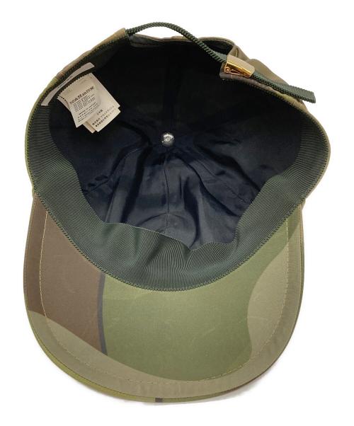 sacai（サカイ）sacai (サカイ) KAWS (カウズ) キャップ グリーンの古着・服飾アイテム