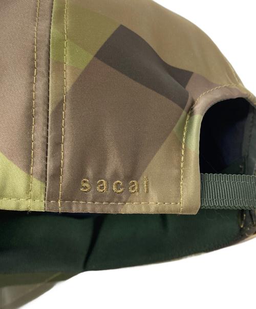 sacai（サカイ）sacai (サカイ) KAWS (カウズ) キャップ グリーンの古着・服飾アイテム