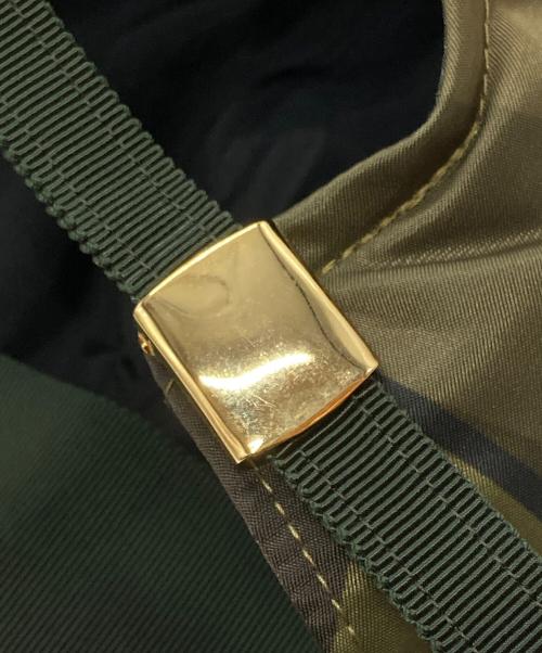 sacai（サカイ）sacai (サカイ) KAWS (カウズ) キャップ グリーンの古着・服飾アイテム