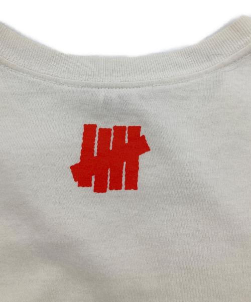 UNDEFEATED（アンディフィーテッド）UNDEFEATED (アンディフィーテッド) VERDY (ヴェルディ) コラボプリントTシャツ ホワイト サイズ:Mの古着・服飾アイテム