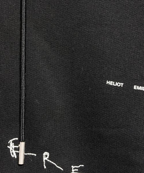 HELIOT EMIL（ヘリオットエミル）HELIOT EMIL (ヘリオットエミル) graphic-print hoodie/グラフィックプリントフーディー ブラック サイズ:Lの古着・服飾アイテム