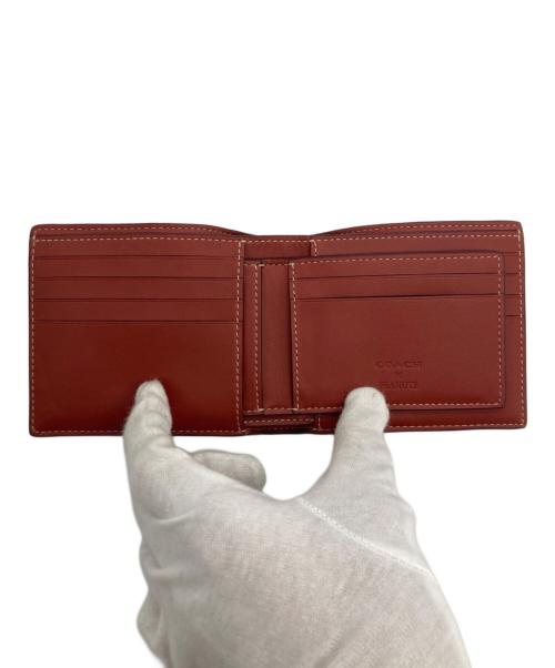 COACH（コーチ）COACH (コーチ) PEANUTS (ピーナッツ) ウォレット・シグネチャー・スヌーピー ウッドストック ベージュの古着・服飾アイテム