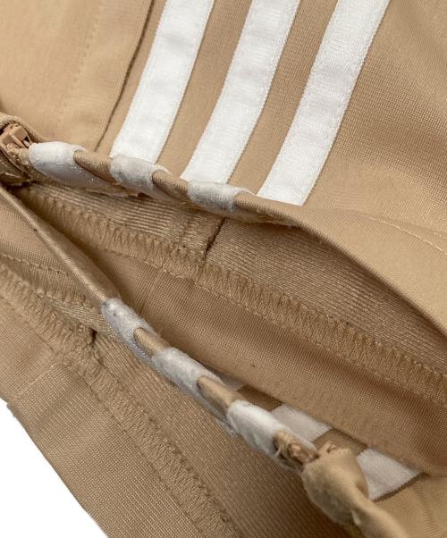 adidas（アディダス）adidas (アディダス) アディカラー クラシックス ファイヤーバード トラックパンツ ベージュ サイズ:Sの古着・服飾アイテム