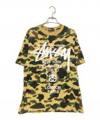 A BATHING APE×stussyアベイシングエイプ×ステューシー）の古着「30周年記念 1stカモ 猿迷彩 ワールドツアー Tシャツ」｜ベージュ×グリーン