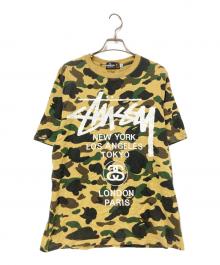 A BATHING APE×stussy（アベイシングエイプ×ステューシー）の古着「30周年記念 1stカモ 猿迷彩 ワールドツアー Tシャツ」｜ベージュ×グリーン