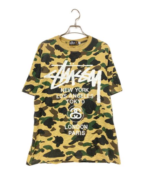 A BATHING APE（アベイシングエイプ）A BATHING APE (アベイシングエイプ) stussy (ステューシー) 30周年記念 1stカモ 猿迷彩 ワールドツアー Tシャツ ベージュ×グリーン サイズ:Mの古着・服飾アイテム