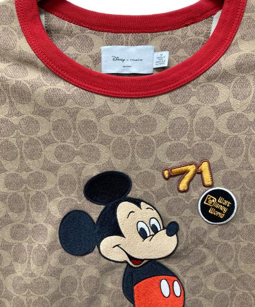 COACH（コーチ）COACH (コーチ) DISNEY (ディズニー) ミッキーマウス シグネチャー Tシャツ ベージュ サイズ:Mの古着・服飾アイテム