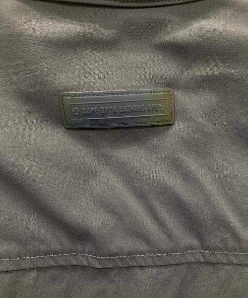 Aape BY A BATHING APE（エーエイプ バイ アベイシングエイプ）Aape BY A BATHING APE (エーエイプ バイ アベイシングエイプ) ポケットコーチジャケット/AAPSTM8372XXG グレー サイズ:Ｌの古着・服飾アイテム