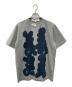 TAO COMME des GARCONS（タオ コムデギャルソン）の古着「DAICHIROSHINJO製品プリントTシャツ/TM-T021」｜グレー