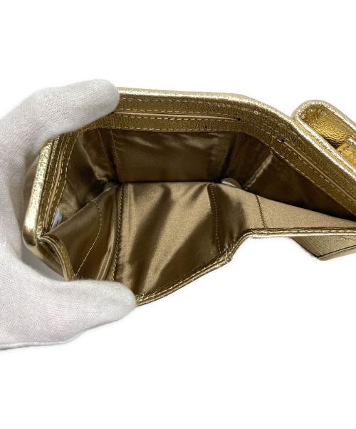 Hashibami（ハシバミ）HASHIBAMI (ハシバミ) レザーリボン3つ折り財布 ゴールドの古着・服飾アイテム