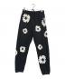 Denim Tears（デニムティアーズ）の古着「Cotton Wreath-print track pants」｜ブラック