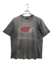 stussy（ステューシー）の古着「オーバルロゴプリントTシャツ」｜ブラック