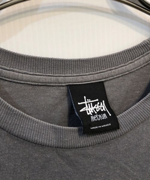 stussy（ステューシー）stussy (ステューシー) 【古着】Stand Firm Dino Tee/スタンドファームダイノTシャツ グレー サイズ:SIZE Mの古着・服飾アイテム