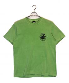 stussy（ステューシー）の古着「サーフマン半袖Tシャツ」｜グリーン