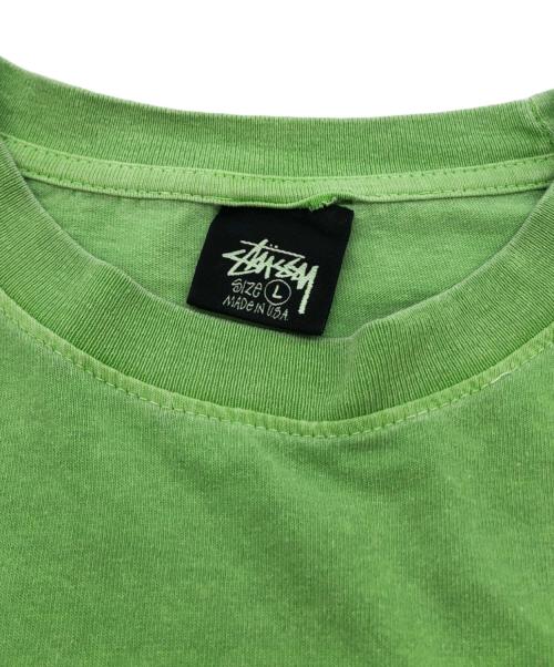 stussy（ステューシー）stussy (ステューシー) サーフマン半袖Tシャツ グリーン サイズ:Lの古着・服飾アイテム