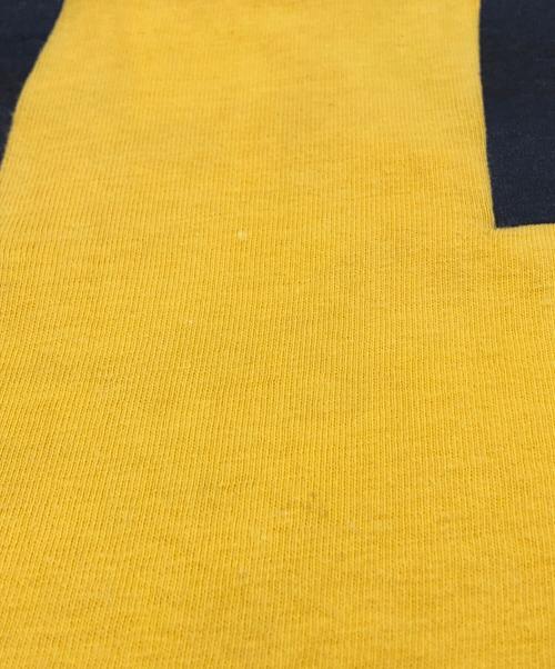 Champion（チャンピオン）Champion (チャンピオン) 両面プリントフットボールTシャツ イエロー サイズ:LARGEの古着・服飾アイテム