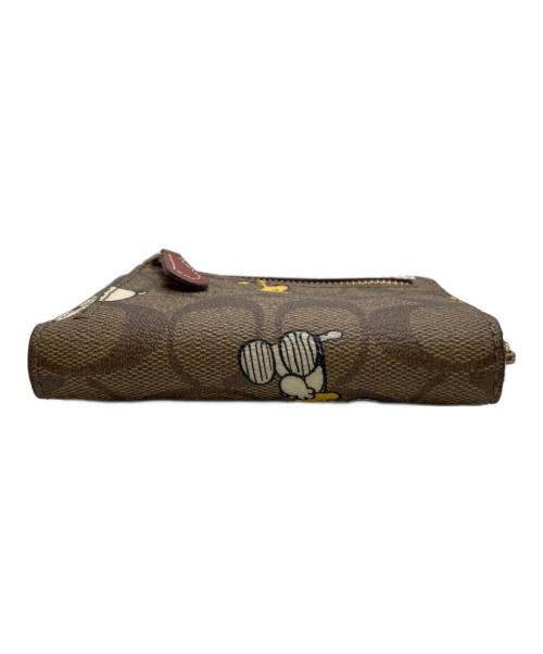 COACH（コーチ）COACH (コーチ) PEANUTS (ピーナッツ) 2つ折り財布 ブラウンの古着・服飾アイテム