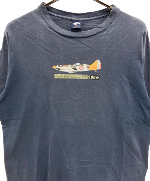 stussy（ステューシー）stussy (ステューシー) INTERNATIONAL SQUADRON プリントTシャツ ネイビー サイズ:XLの古着・服飾アイテム
