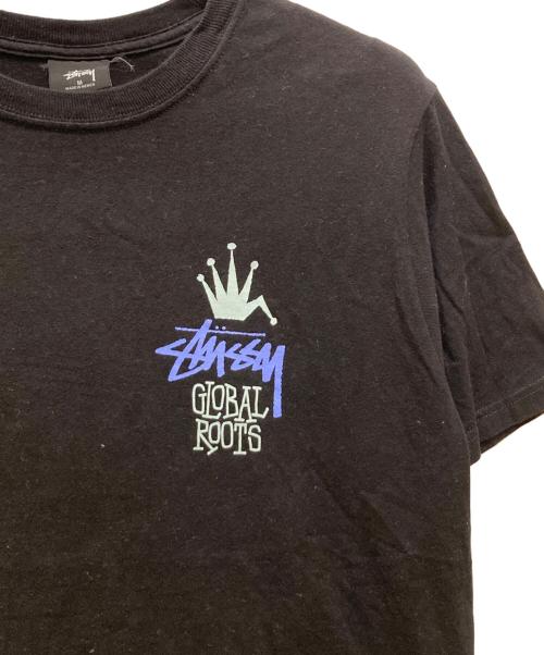 stussy（ステューシー）stussy (ステューシー) グローバルルーツTシャツ ブラック サイズ:Mの古着・服飾アイテム