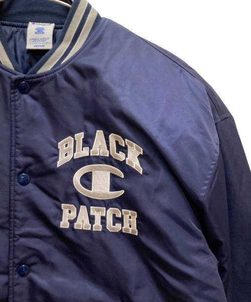 Champion（チャンピオン）Champion (チャンピオン) THE BLACK EYE PATCH (ブラックアイパッチ) コラボロゴスタジャン ネイビー サイズ:Ｍの古着・服飾アイテム