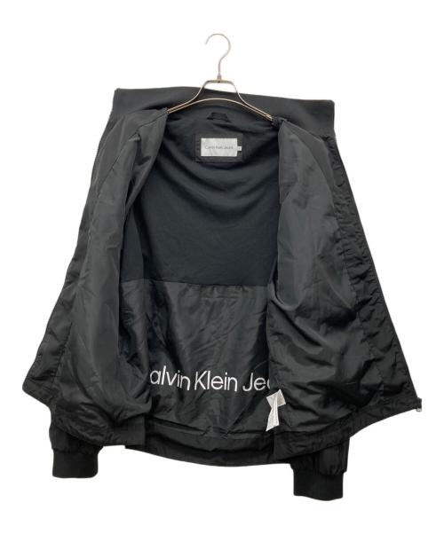 Calvin Klein Jeans（カルバンクラインジーンズ）Calvin Klein Jeans (カルバンクラインジーンズ) ワッペンナイロンジャケット ブラック サイズ:XLの古着・服飾アイテム