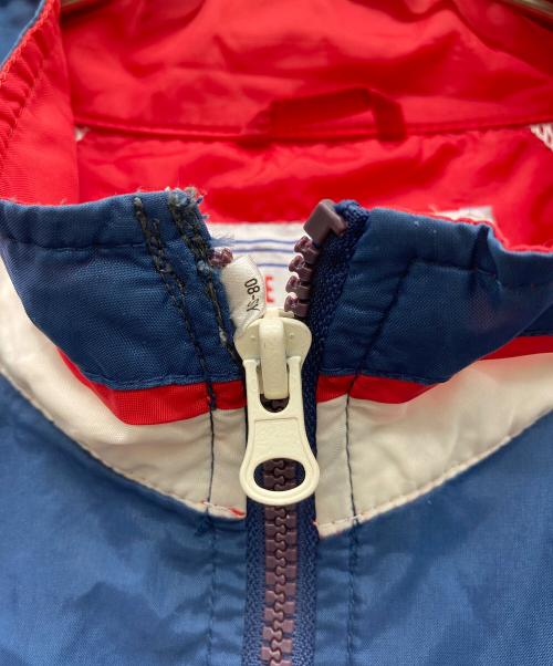 GENUINE MERCHANDISE（ジェニュイン マーチャンダイズ）GENUINE MERCHANDISE (ジェニュイン マーチャンダイズ) インディアンス ナイロンジャケット レッド×ブルー サイズ:XLの古着・服飾アイテム