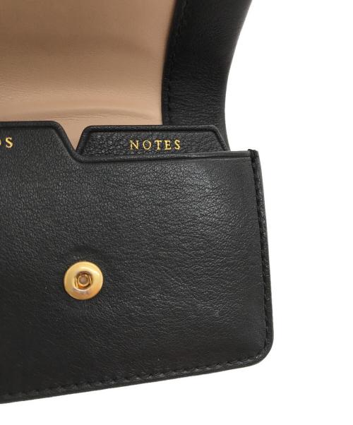 ANYA HINDMARCH（アニヤ・ハインドマーチ）ANYA HINDMARCH (アニヤハインドマーチ) ツイストリボンデザイン 三つ折財布 ブラックの古着・服飾アイテム