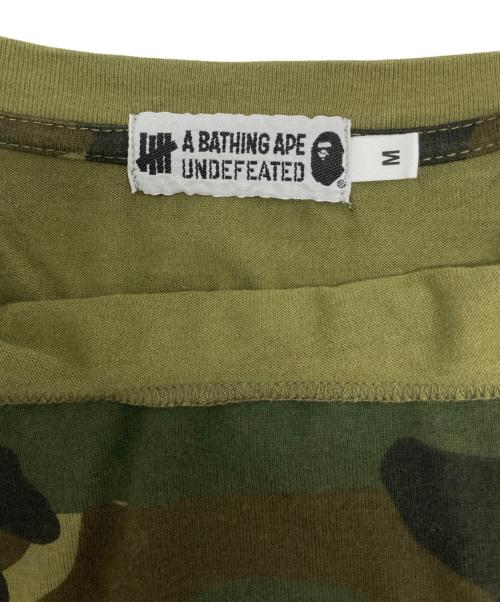 A BATHING APE（アベイシングエイプ）A BATHING APE (アベイシングエイプ) UNDEFEATED (アンディフィーテッド) サルカモTシャツ オリーブ サイズ:Ⅿの古着・服飾アイテム