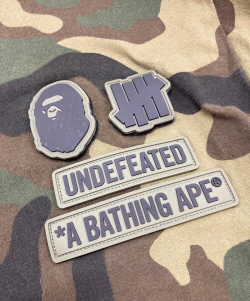 A BATHING APE（アベイシングエイプ）A BATHING APE (アベイシングエイプ) UNDEFEATED (アンディフィーテッド) サルカモTシャツ オリーブ サイズ:Ⅿの古着・服飾アイテム